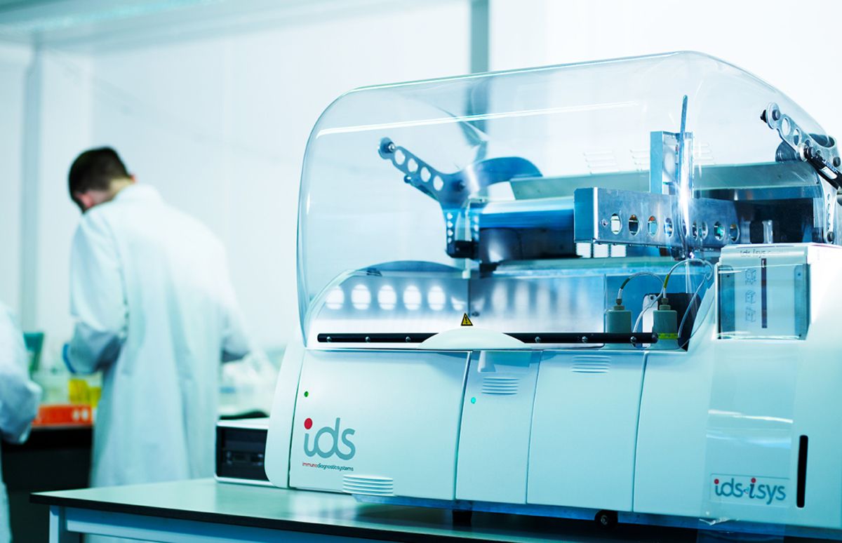 Scientists working in a lab with an IDS machine